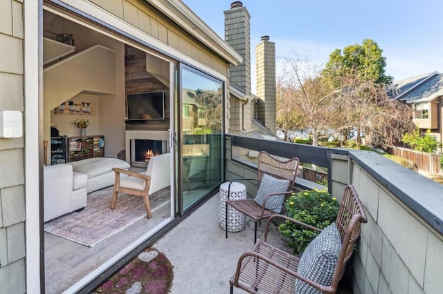 balcony featuring exterior fireplace