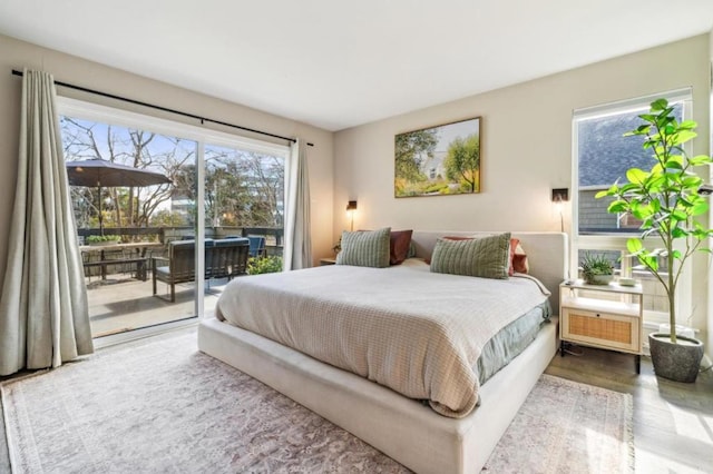 bedroom with wood-type flooring and access to exterior