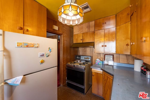 kitchen featuring white fridge and stove