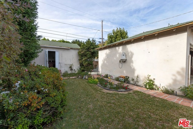 view of side of home with a lawn