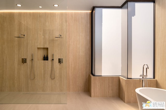 bathroom with tile patterned flooring and independent shower and bath