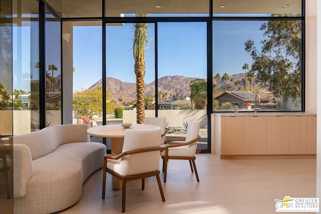 sunroom / solarium featuring a mountain view and plenty of natural light