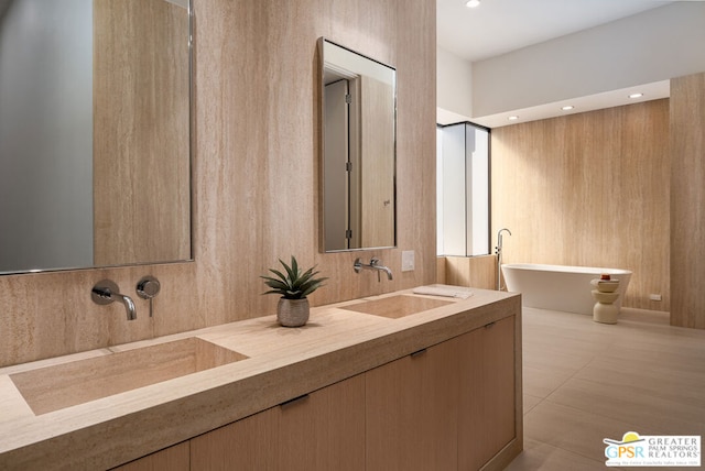 bathroom with vanity and a tub