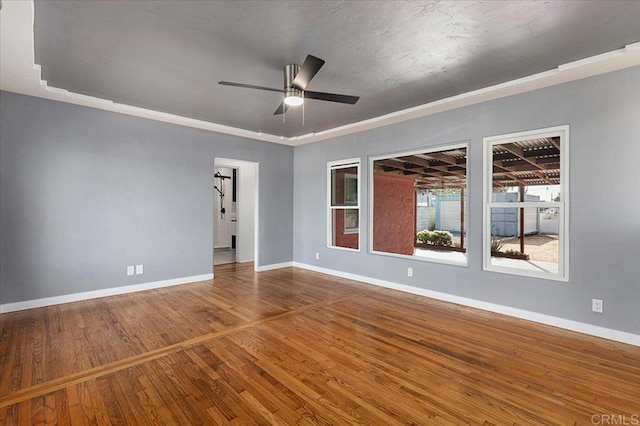 unfurnished room featuring hardwood / wood-style floors and ceiling fan