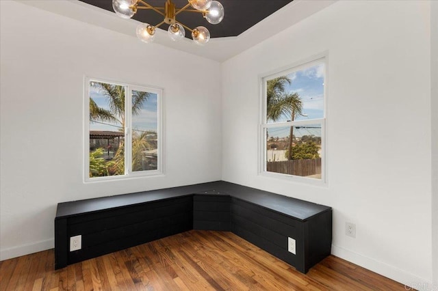 living area featuring hardwood / wood-style flooring, plenty of natural light, and a chandelier