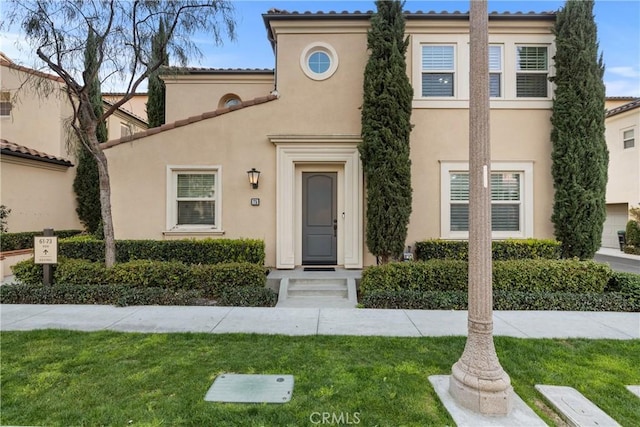 view of front of property with a front yard and stucco siding