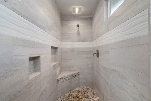 bathroom with tiled shower