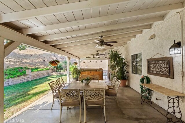 view of patio with a hot tub and ceiling fan