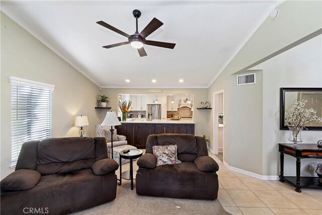 tiled living room featuring crown molding, ceiling fan, and lofted ceiling