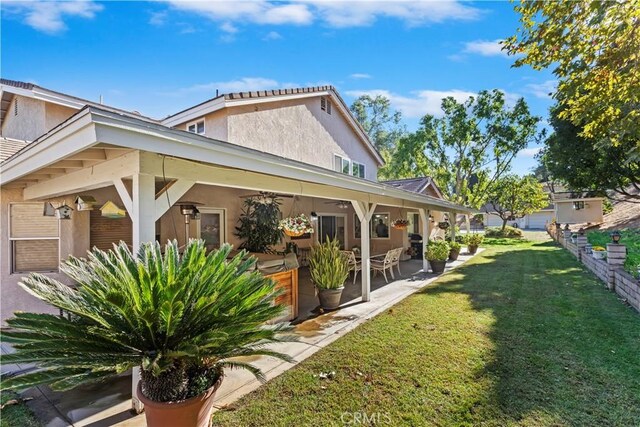 exterior space featuring a yard and a patio area