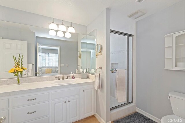 bathroom with vanity, toilet, and walk in shower