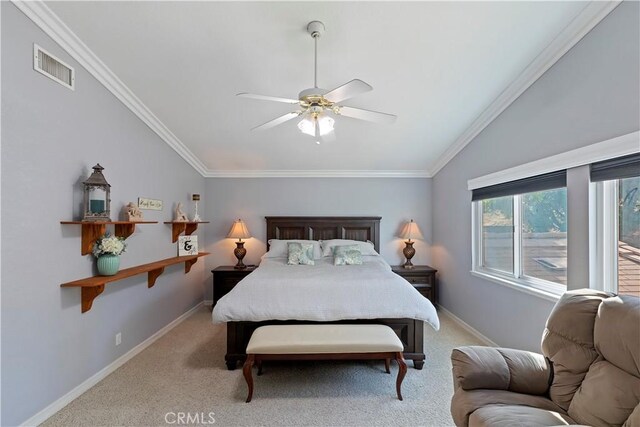 bedroom featuring crown molding, vaulted ceiling, light colored carpet, and ceiling fan