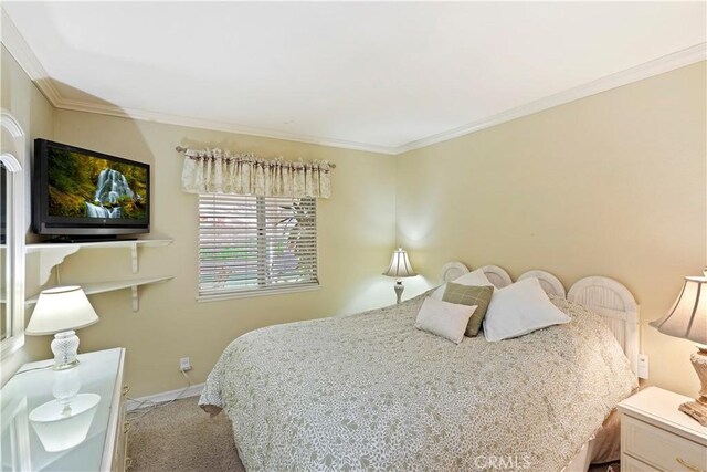 carpeted bedroom with crown molding