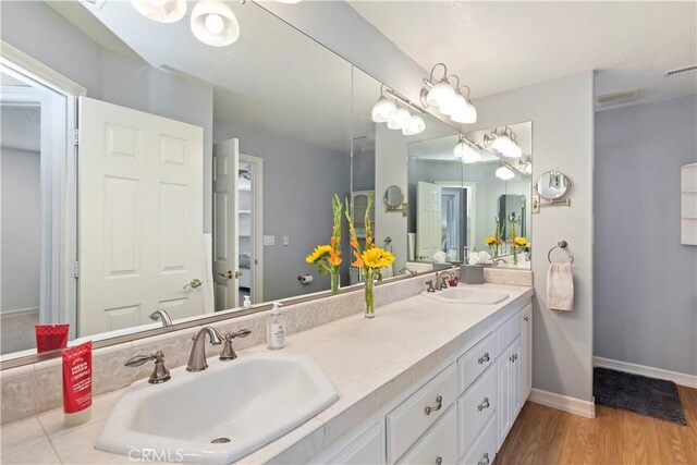 bathroom with vanity and hardwood / wood-style floors