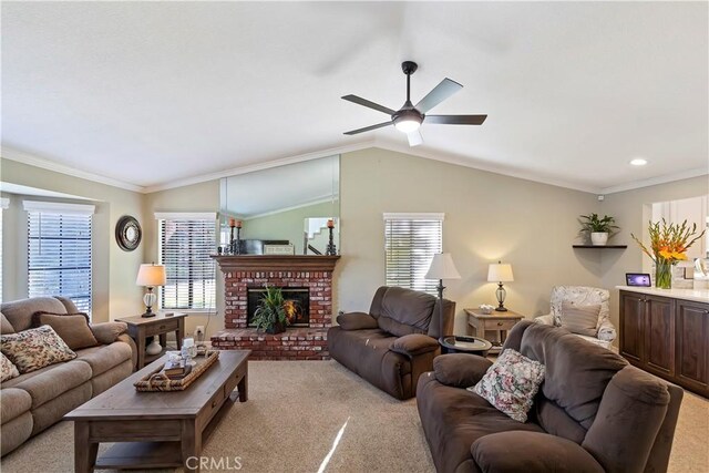 carpeted living room featuring lofted ceiling, a fireplace, ornamental molding, and ceiling fan