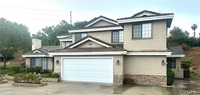 view of front of house featuring a garage and central AC