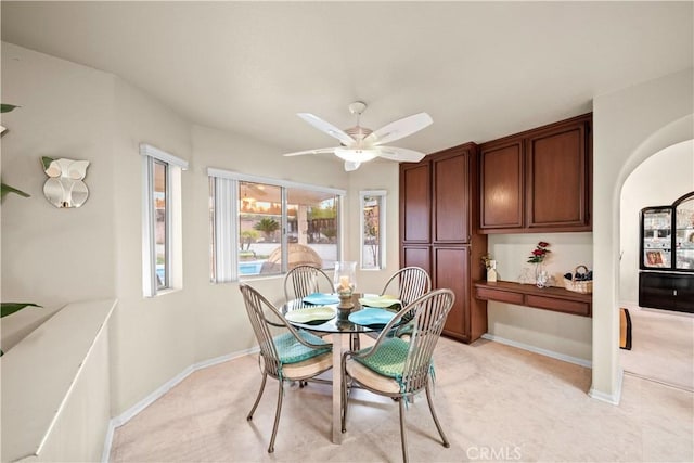 carpeted dining space featuring ceiling fan