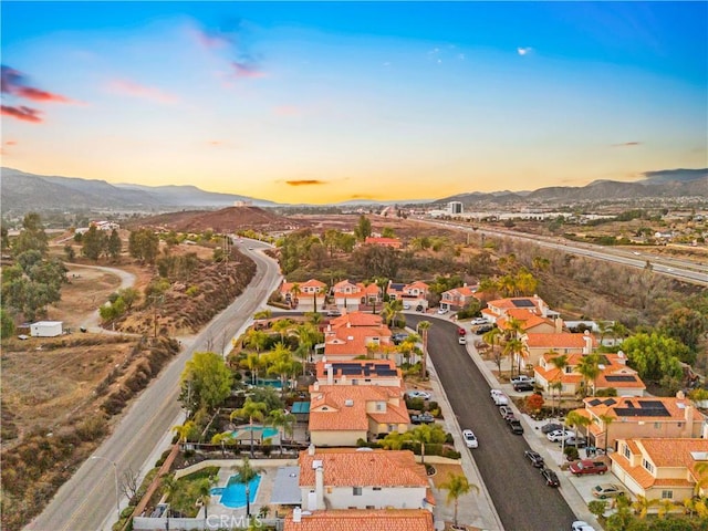 aerial view at dusk featuring a mountain view