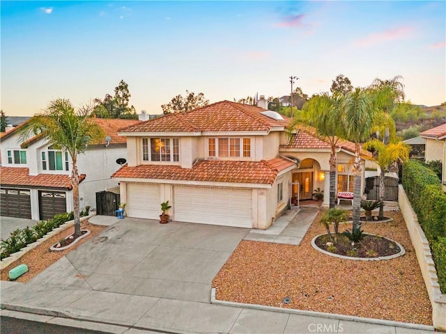 mediterranean / spanish house featuring a garage