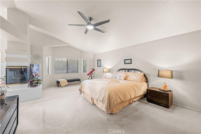 bedroom featuring lofted ceiling, a multi sided fireplace, ceiling fan, and carpet