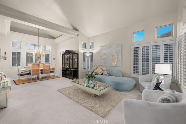 living room featuring high vaulted ceiling, a chandelier, and carpet