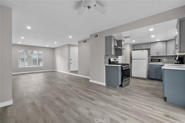 kitchen featuring gray cabinets, appliances with stainless steel finishes, sink, and backsplash