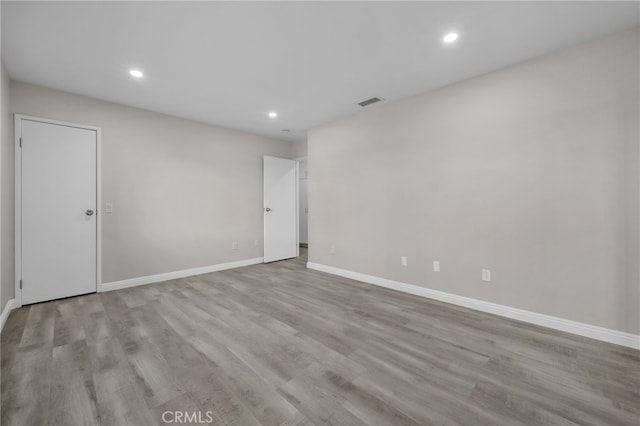 unfurnished room with light wood-type flooring