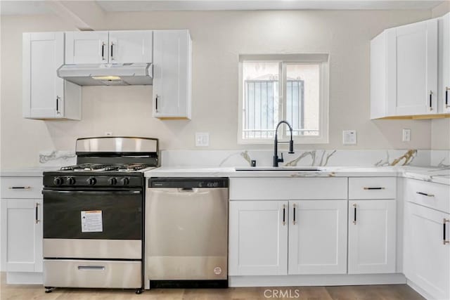 kitchen featuring sink, range with gas cooktop, white cabinetry, light stone counters, and dishwasher