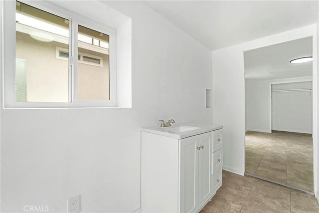 bathroom with vanity and a wealth of natural light