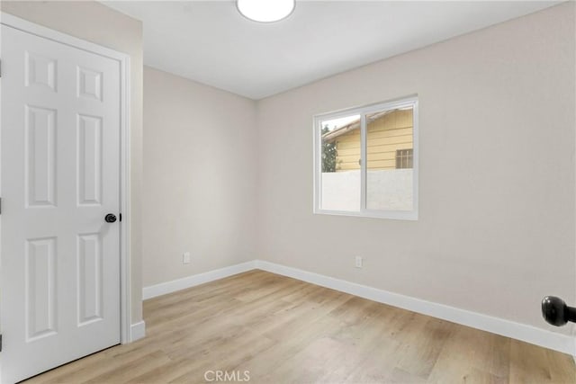 spare room with light hardwood / wood-style flooring