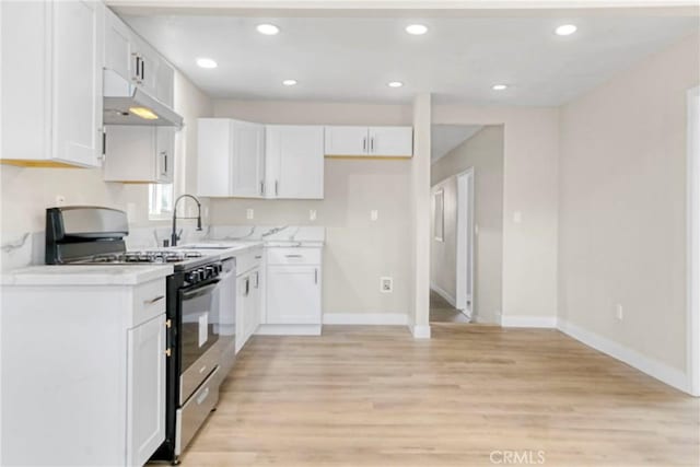 kitchen with light hardwood / wood-style flooring, sink, stainless steel range with gas cooktop, and white cabinets