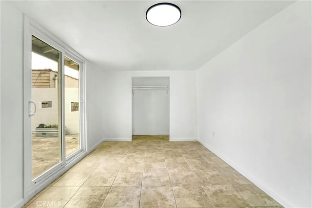 unfurnished bedroom with light tile patterned floors and a closet