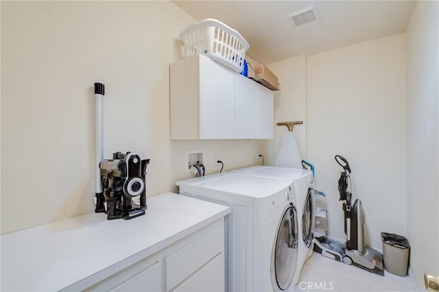 laundry room featuring cabinets and washing machine and clothes dryer