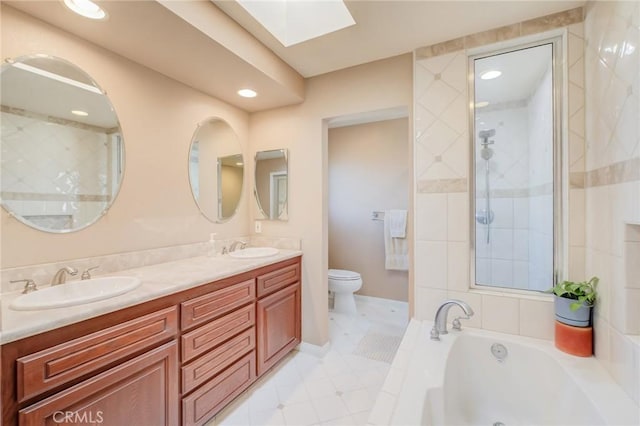 full bathroom featuring vanity, toilet, a skylight, and shower with separate bathtub