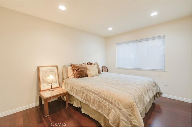 bedroom with dark hardwood / wood-style flooring