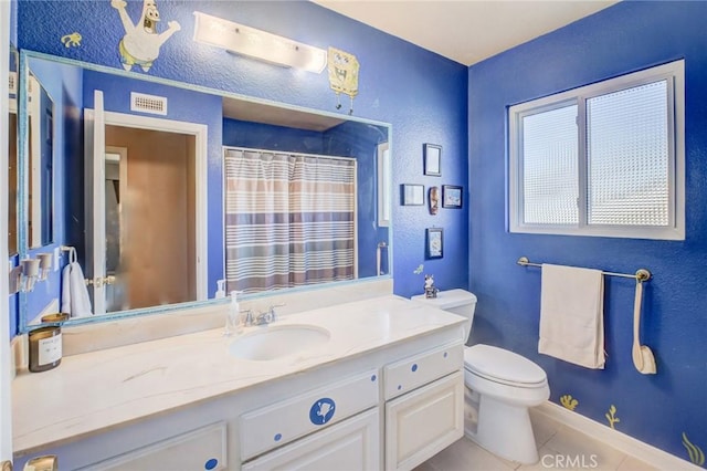 bathroom featuring tile patterned flooring, vanity, toilet, and a shower with shower curtain