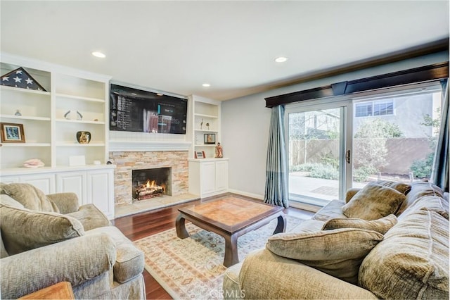 living room with hardwood / wood-style floors and a fireplace