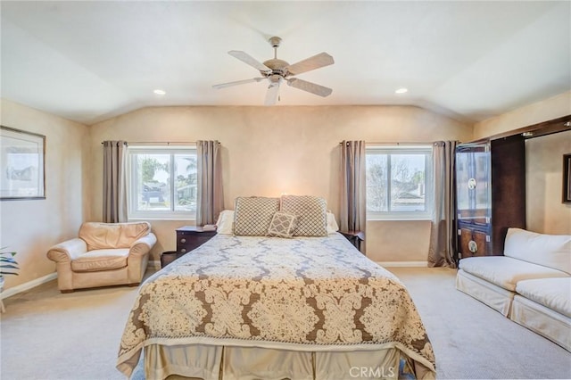 bedroom with multiple windows, lofted ceiling, and light carpet