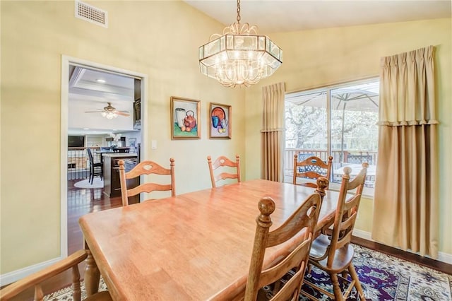 dining room with hardwood / wood-style floors and a chandelier