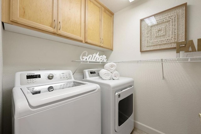 laundry area featuring cabinets and washer and dryer