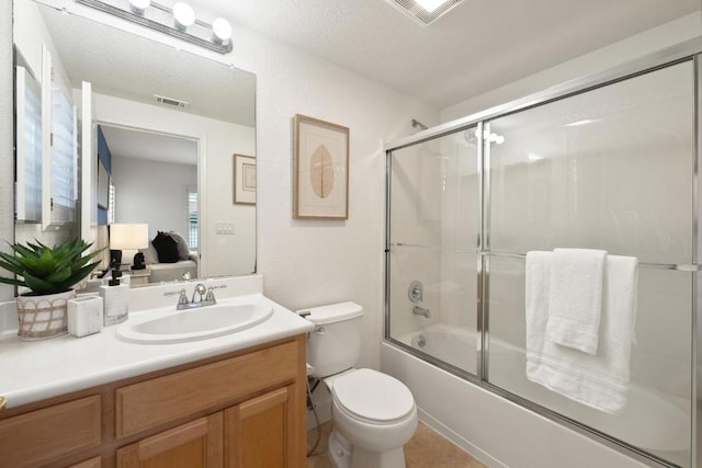 full bathroom with vanity, enclosed tub / shower combo, and toilet