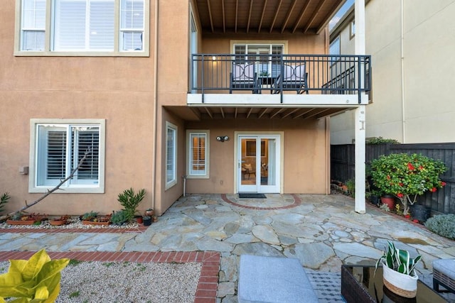 rear view of house with a patio and a balcony