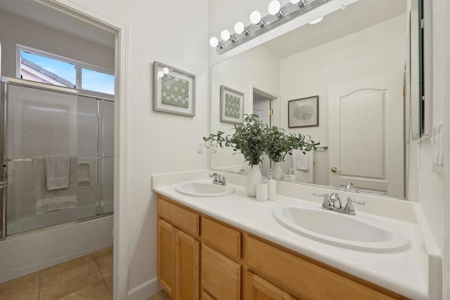 bathroom with tile patterned flooring, vanity, and shower / bath combination with glass door