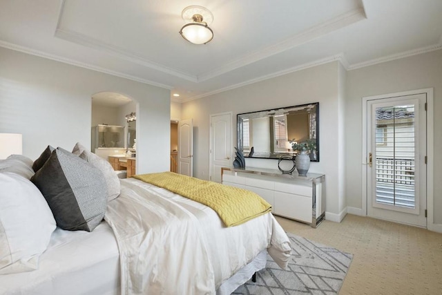 carpeted bedroom featuring crown molding, a tray ceiling, and access to exterior