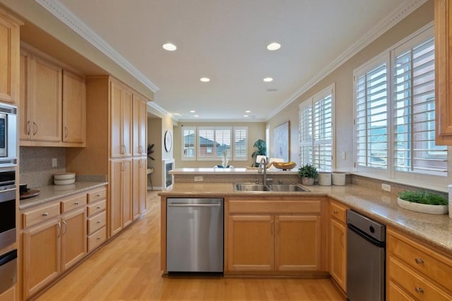 kitchen featuring sink, light brown cabinets, light wood-type flooring, ornamental molding, and stainless steel appliances