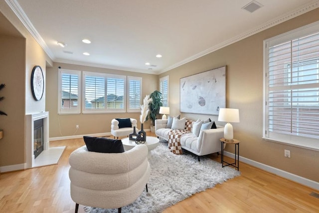 living room with crown molding and light wood-type flooring