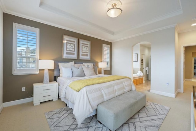 bedroom with crown molding, a tray ceiling, and light colored carpet