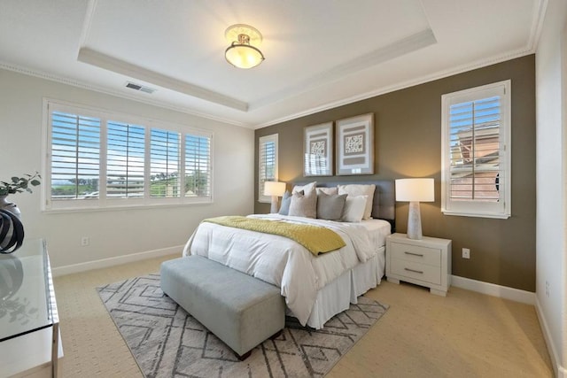 bedroom with light colored carpet, ornamental molding, and a raised ceiling