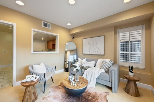 living room featuring light colored carpet and a wealth of natural light