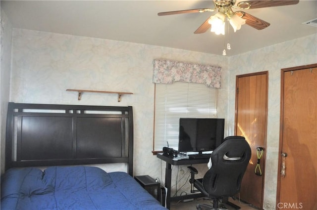 bedroom with ceiling fan and multiple closets